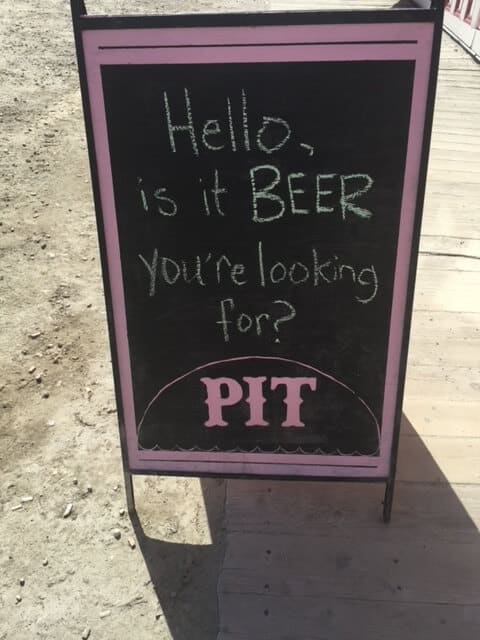 Sidewalk sign reads "Hello, is it beer you're looking for?"