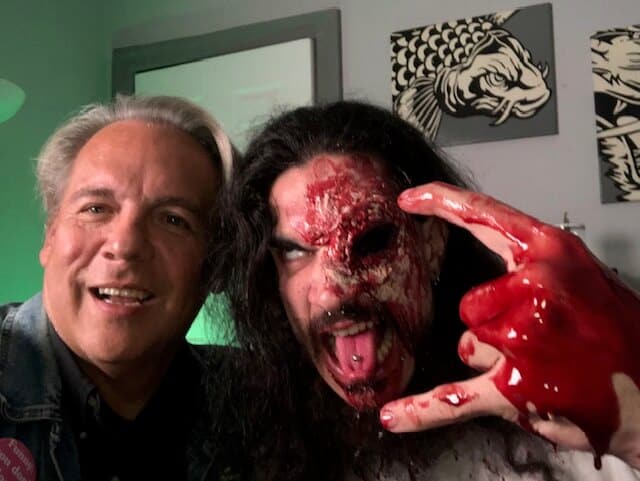 Drew takes a selfie with a man wearing bloody gore makeup